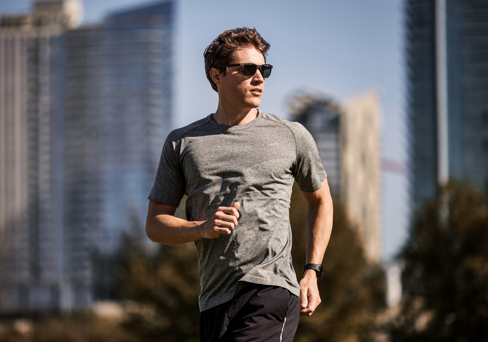 Man running in city wearing Zilker sunglasses