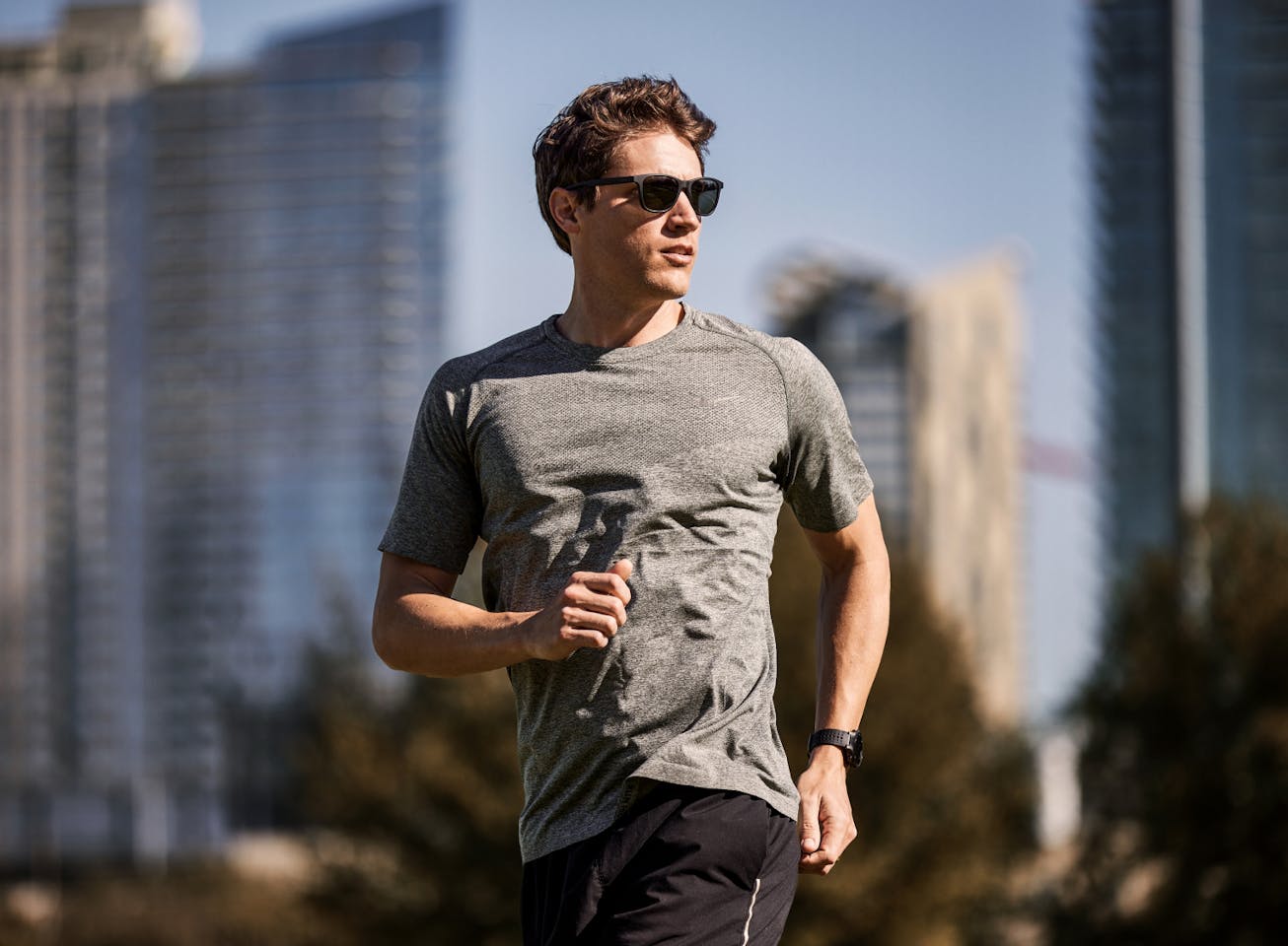 Man running in city wearing Zilker sunglasses