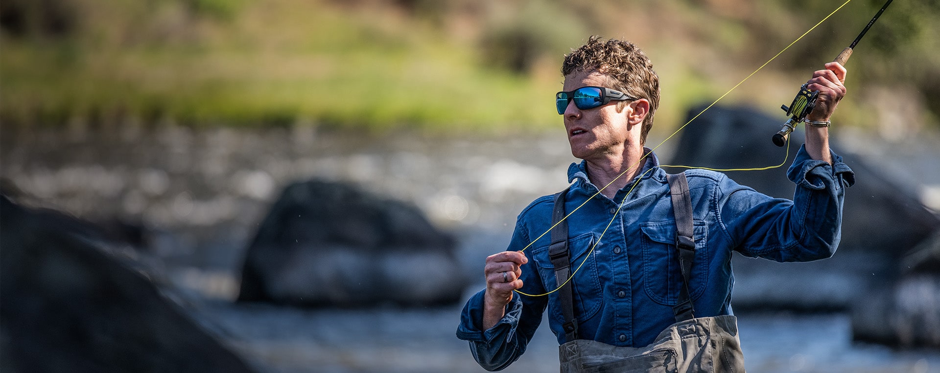 Man fly fishing wearing ROKA sunglasses