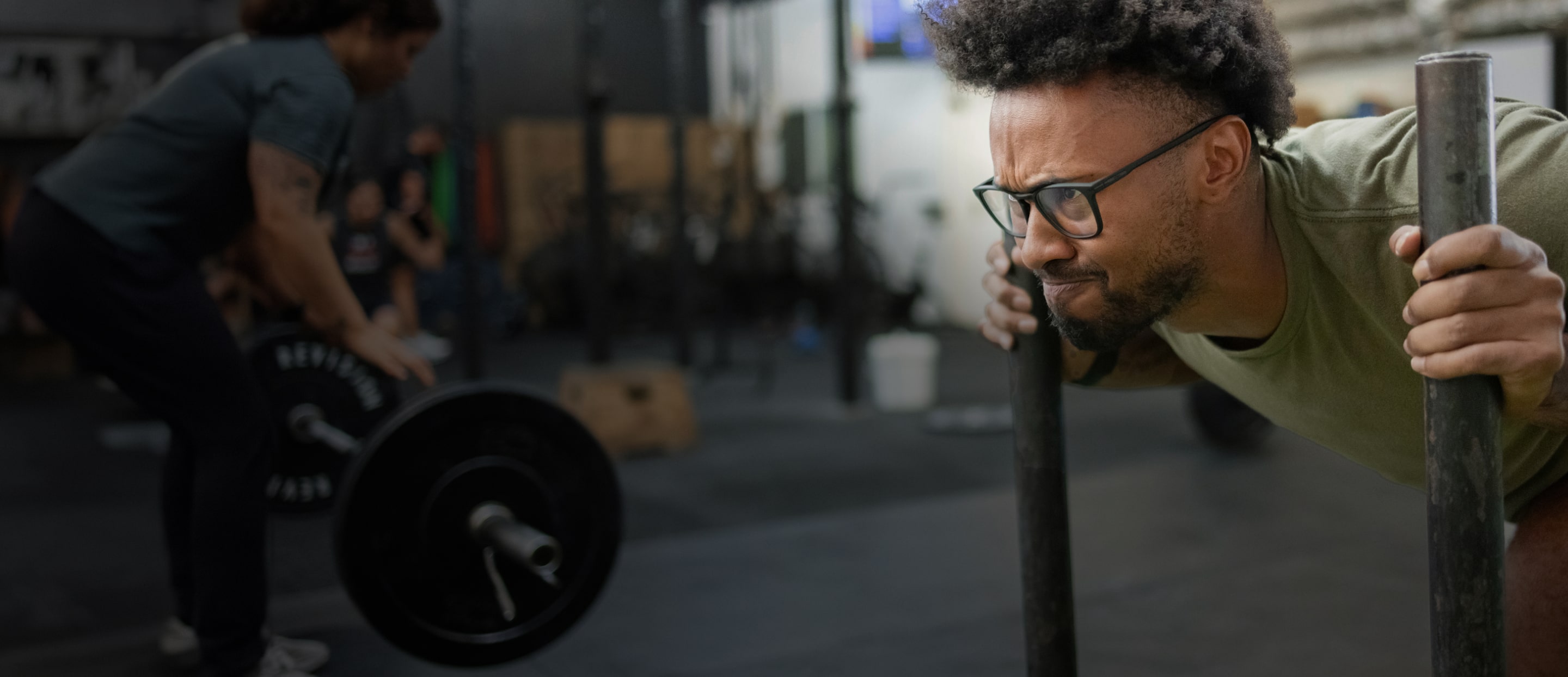 Man pushing workout sled wearing black Rory eyeglasses test