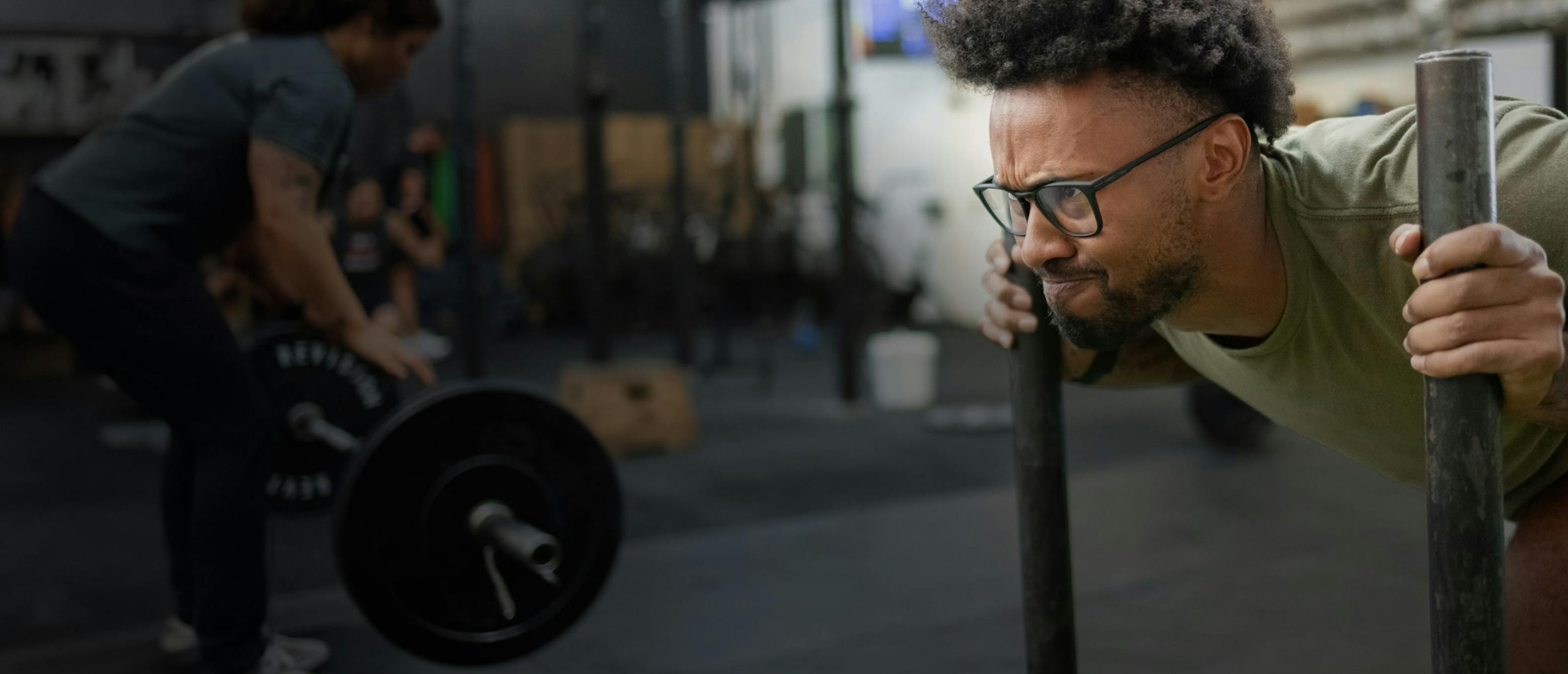 Man pushing workout sled wearing black Rory eyeglasses test