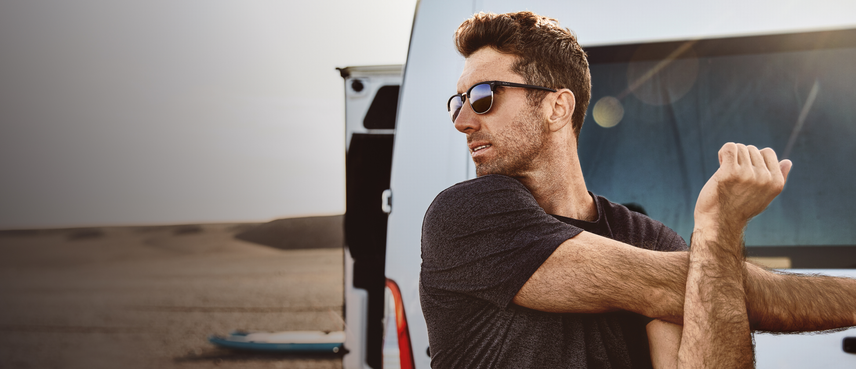 Man stretching wearing Cambridge sunglasses