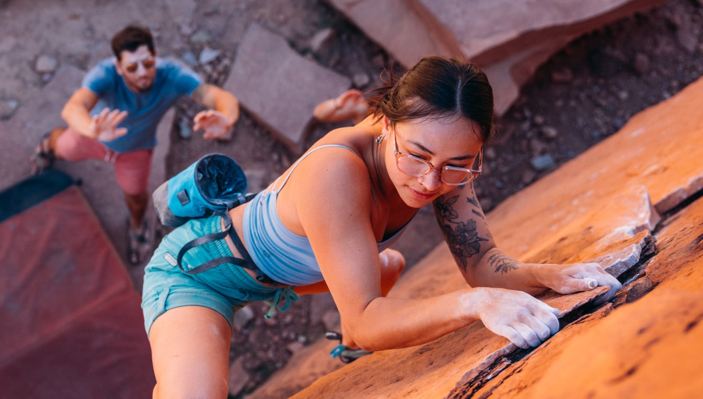 Woman climbing wearing cat eye shape, matte black Lola eyeglasses 
