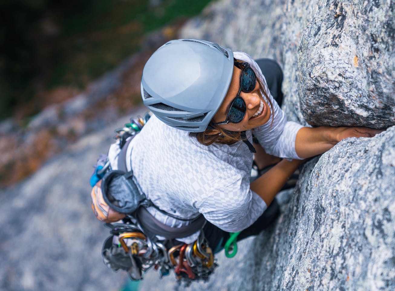 Woman rock climbing wearing Oslo sunglasses