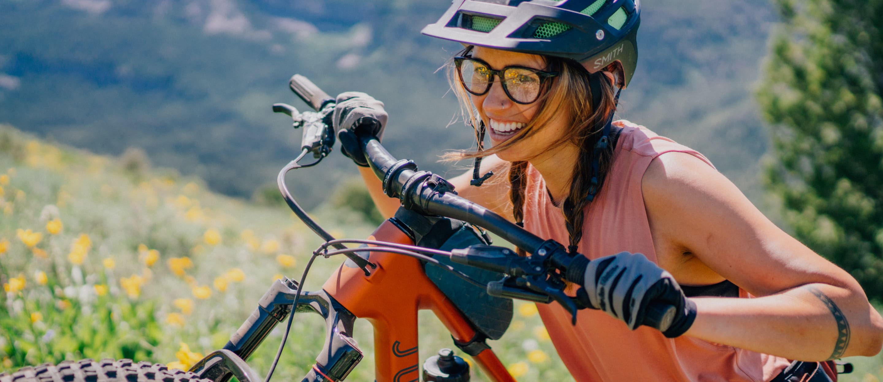 Woman riding bike wearing cat eye shape, clear Lola eyeglasses