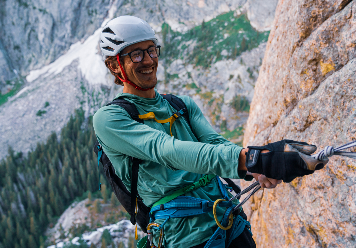 Man climbing wearing rectangular, matte black Rory eyeglasses