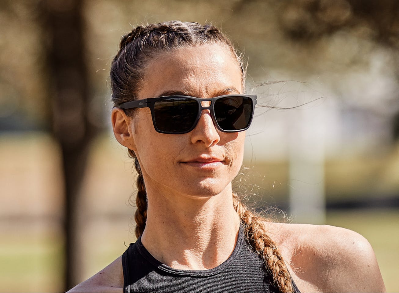 Woman outside wearing Kona sunglasses
