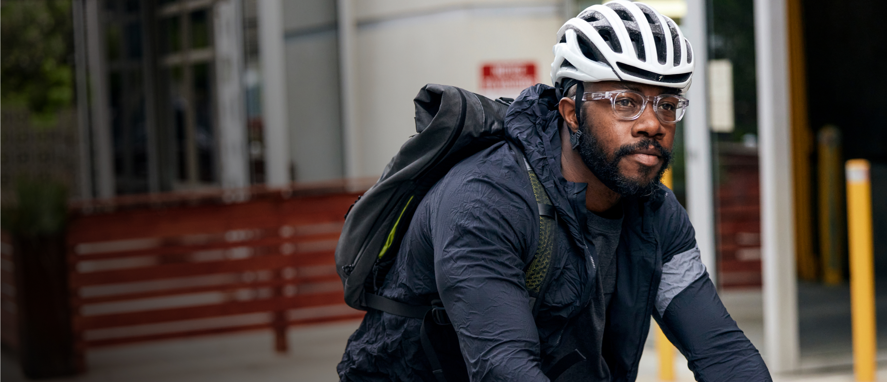 Man riding bike wearing Hamilton eyeglasses