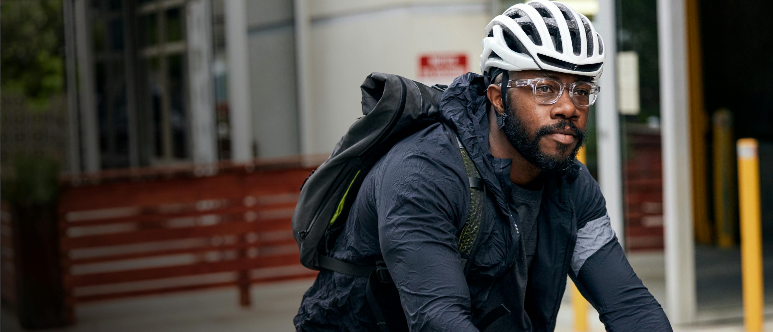 Man riding bike wearing Hamilton eyeglasses