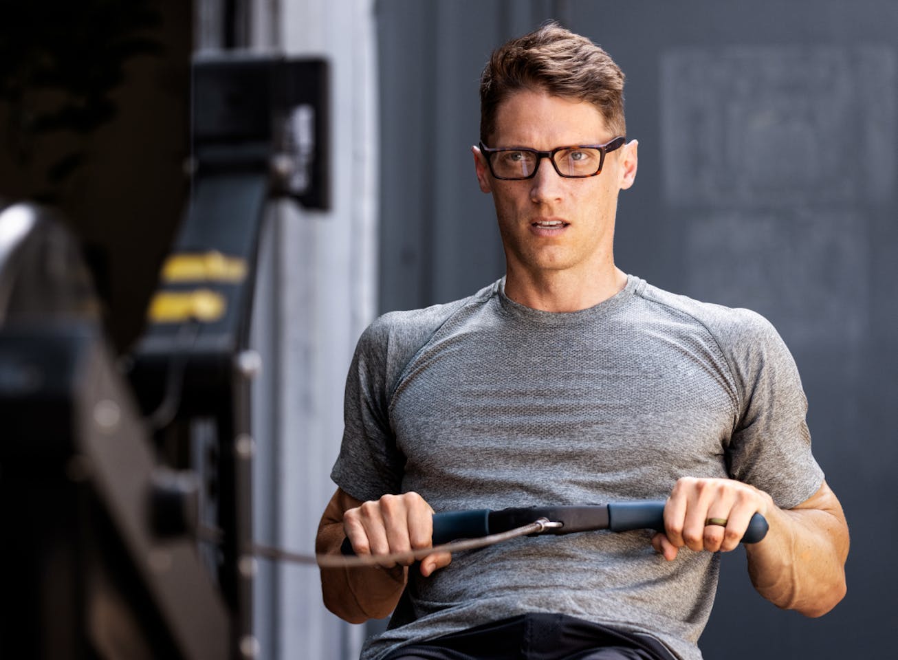 Man using rower machine wearing Mayfield eyeglasses
