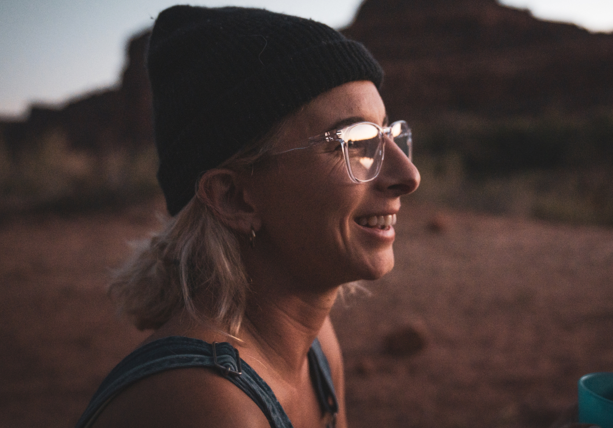 Woman smiling wearing square, clear Hunter eyeglasses