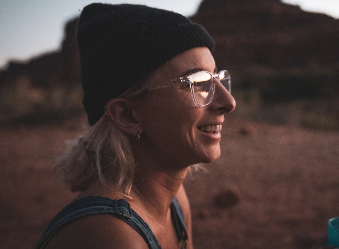 Woman smiling wearing square, clear Hunter eyeglasses
