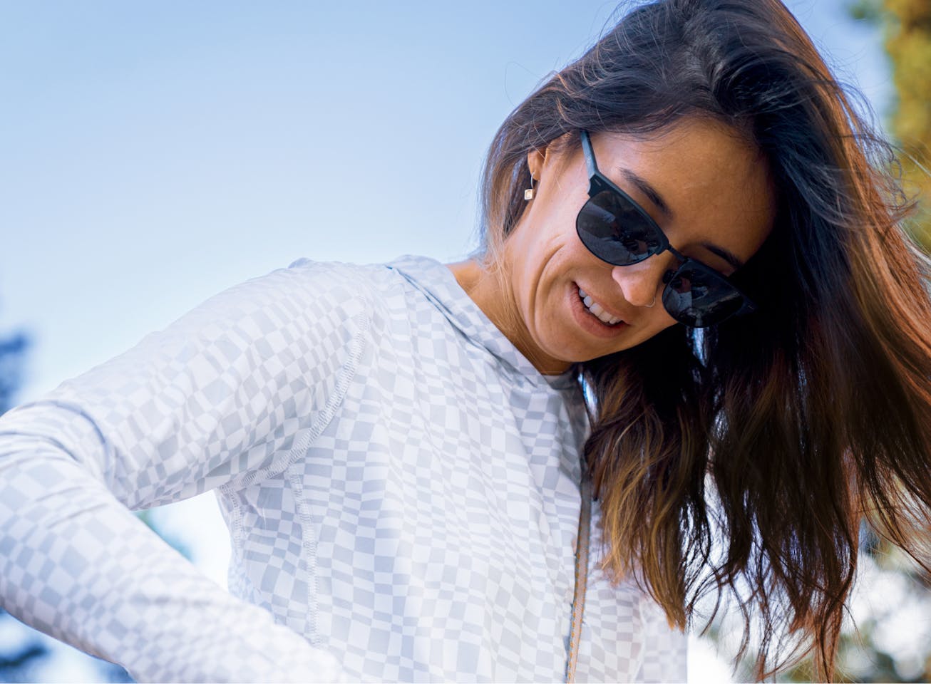 Woman looking down wearing Cambridge sunglasses