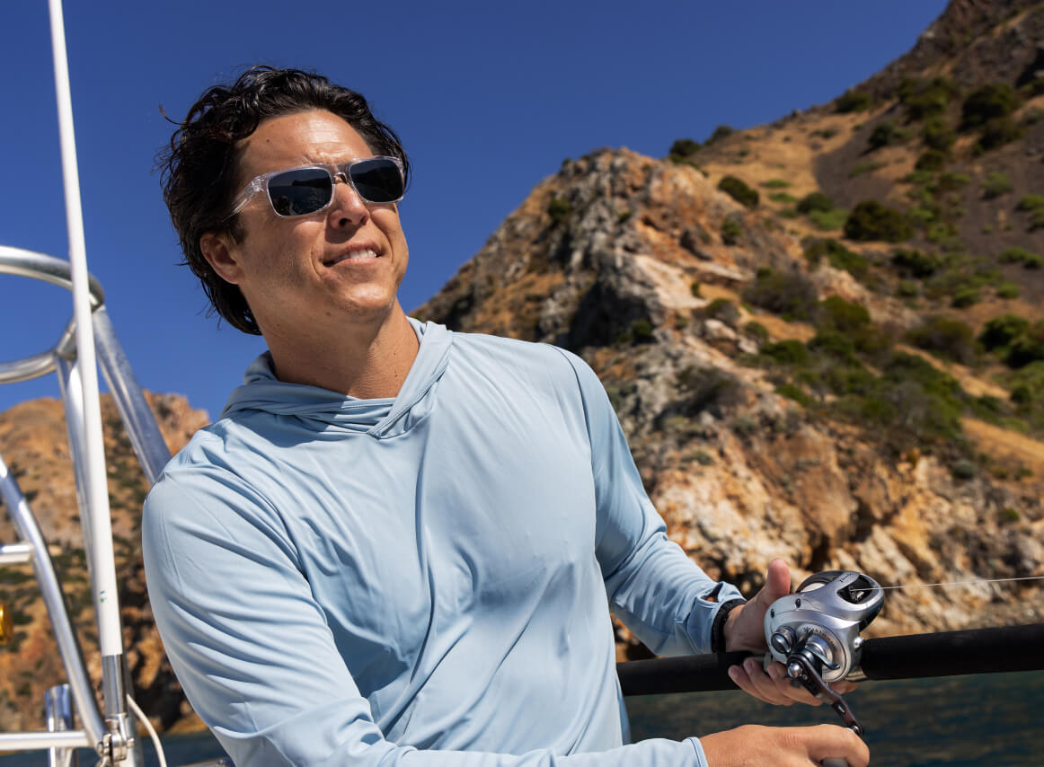 Man fishing on boat wearing Braker sunglasses