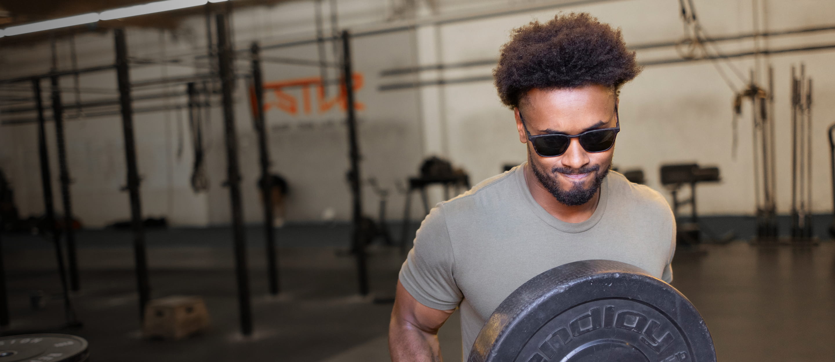 Man working out in gym wearing Rory sunglasses