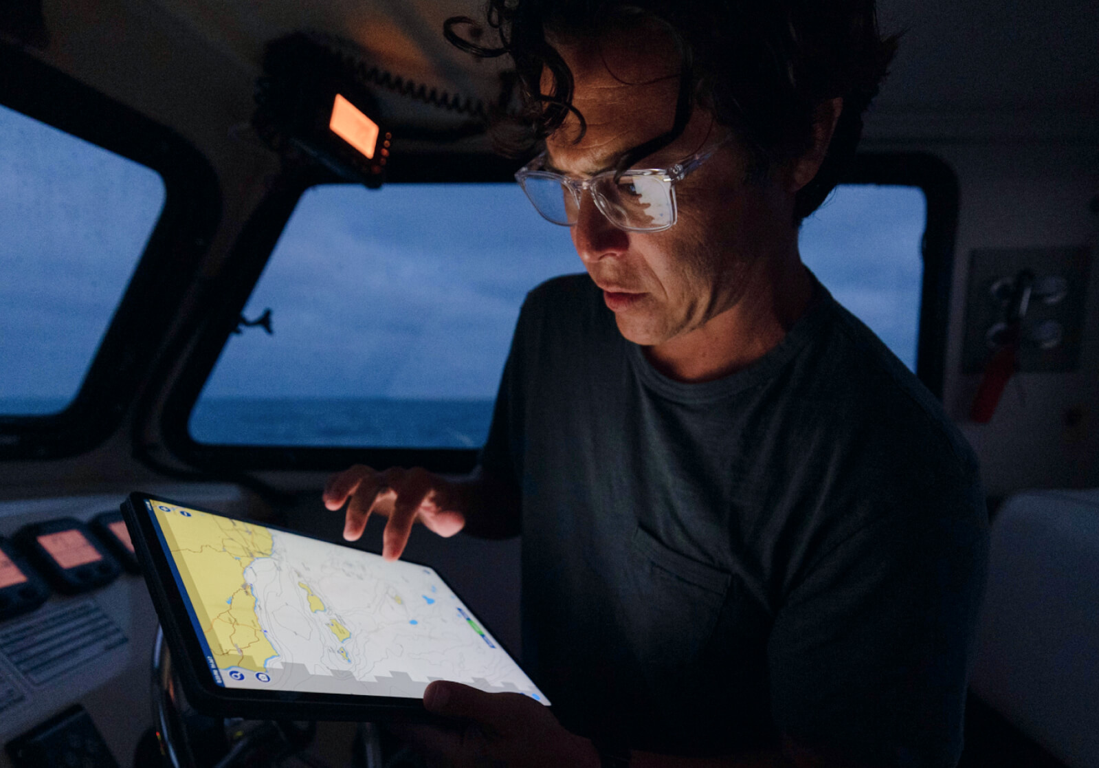 Man in a boat using tablet