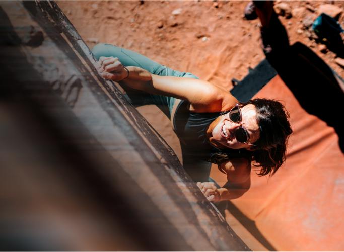 Woman climbing in ROKA sunglasses