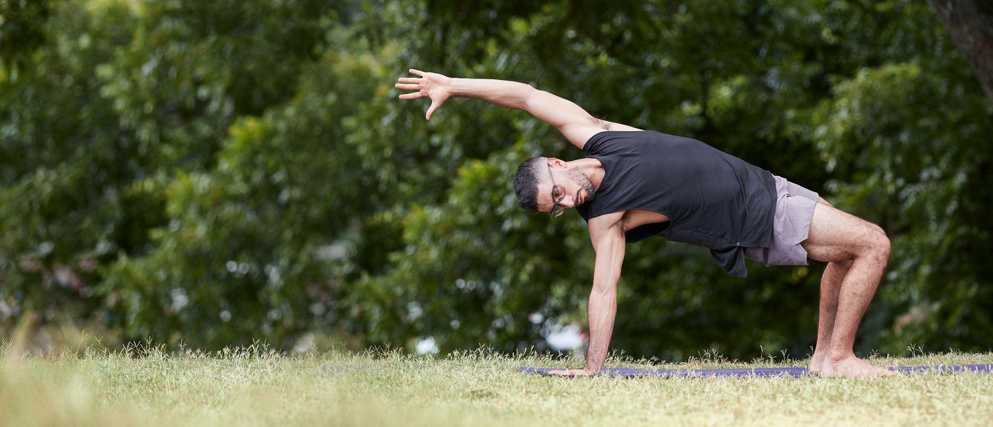 Man doing yoga outside wearing Zilker eyeglasses