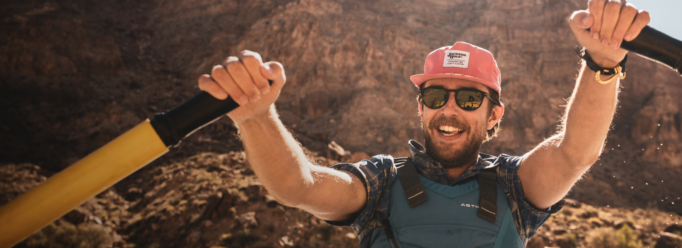 Man kayaking in canyon wearing Oslo sunglasses