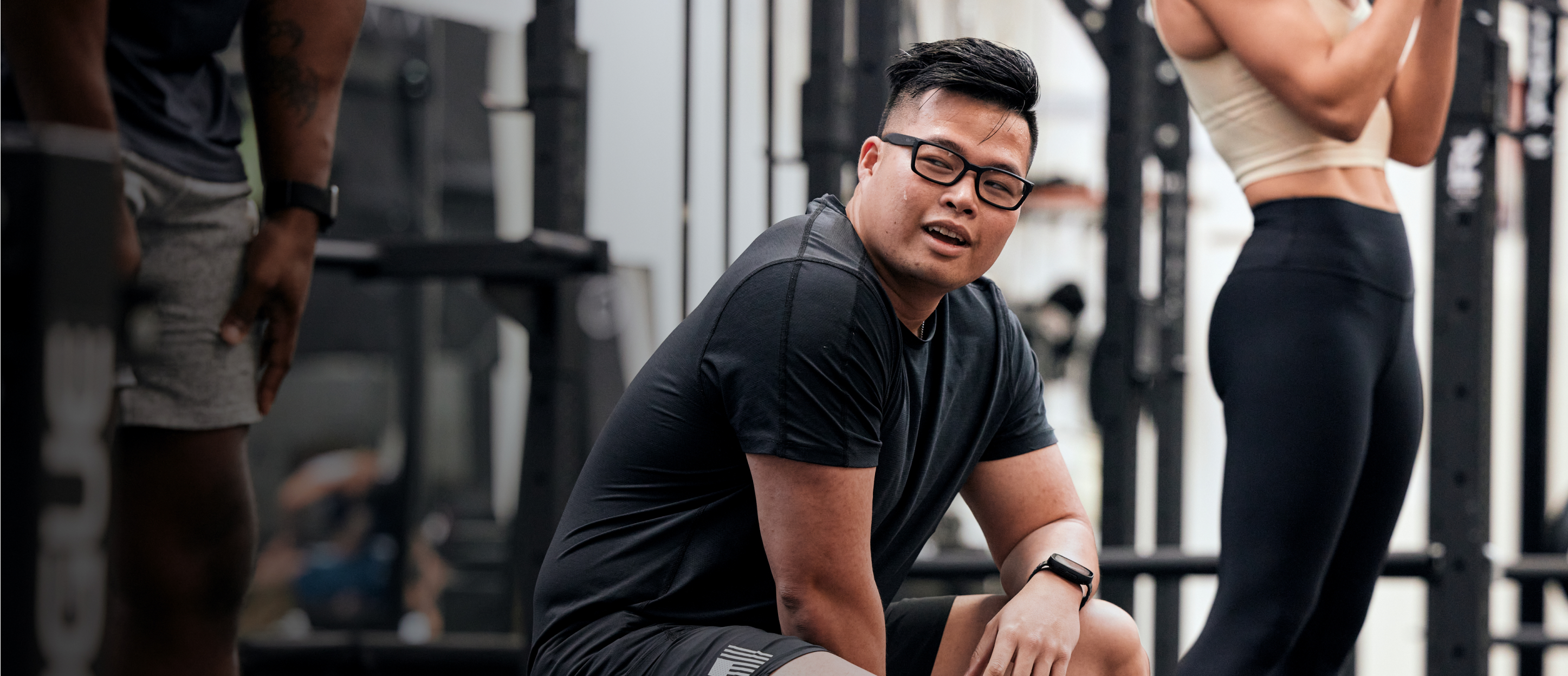 Man resting in gym wearing Mayfield eyeglasses