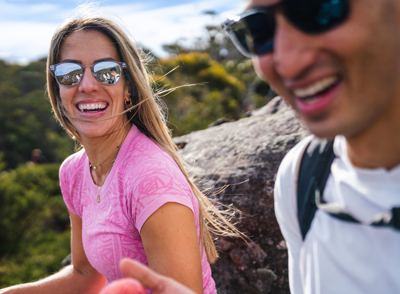 Woman and man smiling wearing Hunter sunglasses
