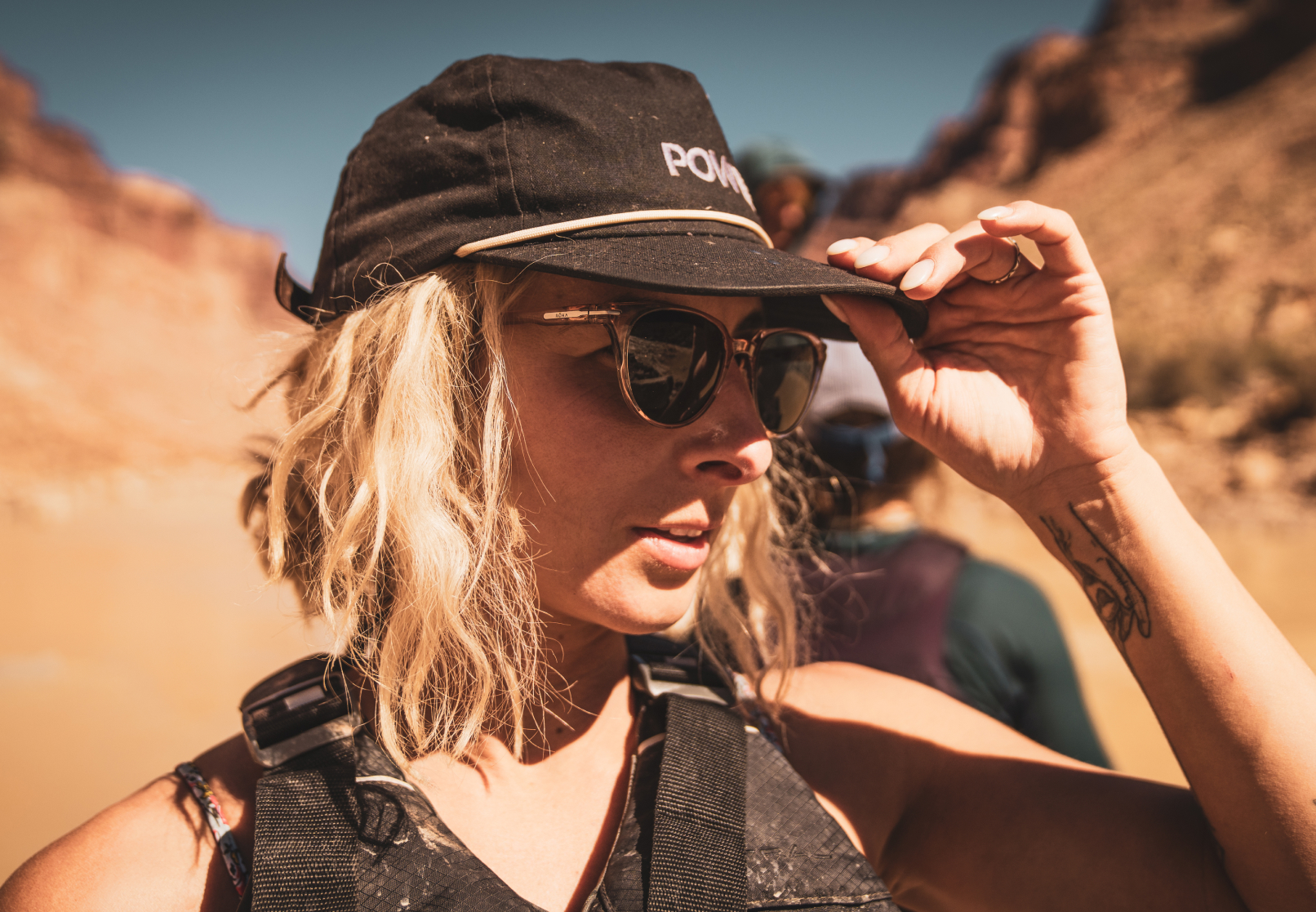 Woman in black hat hiking in canyon