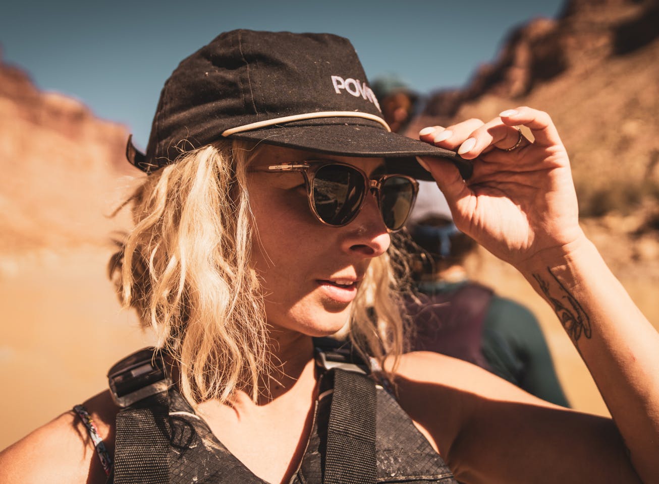Woman in black hat hiking in canyon