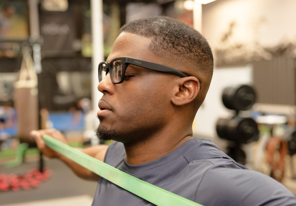 Man using workout band wearing Lockhart eyeglasses