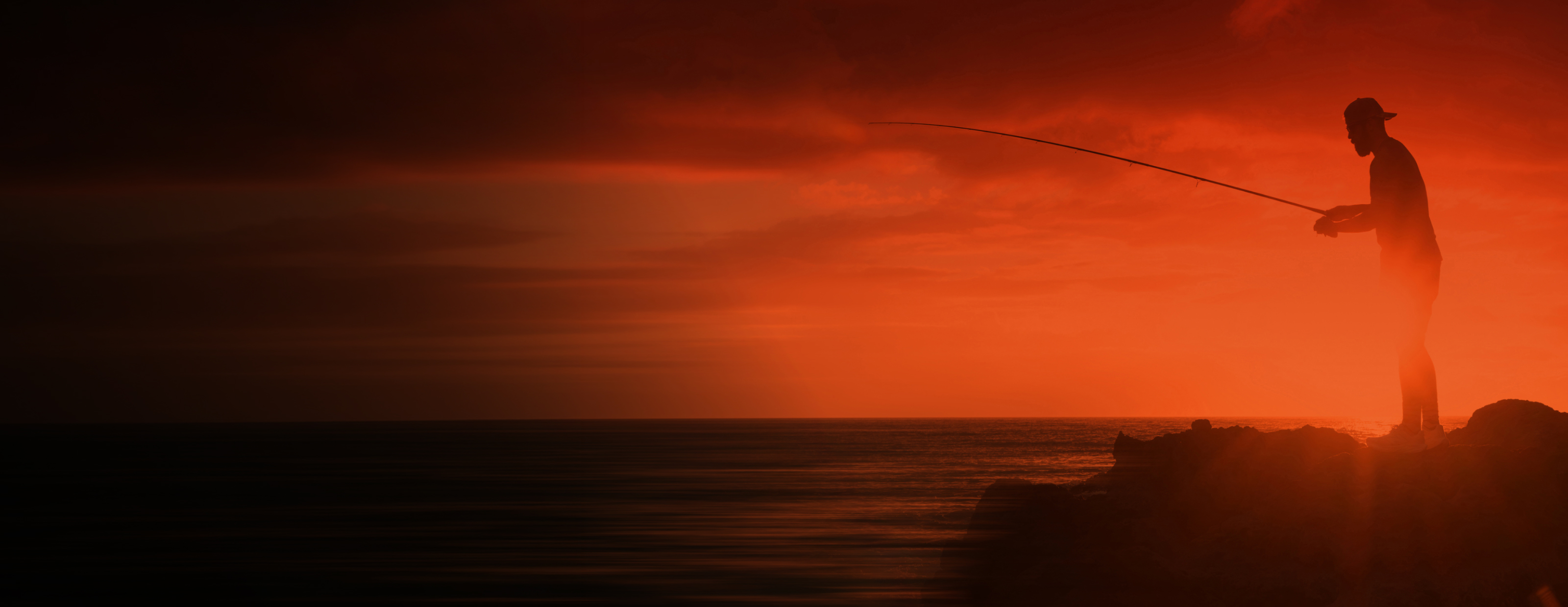 Man fishing at sunset