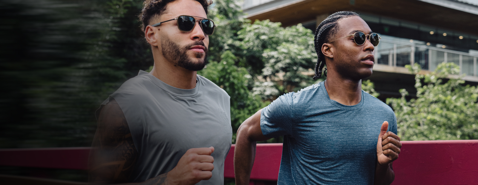 Two men running on bridge wearing ROKA sunglasses