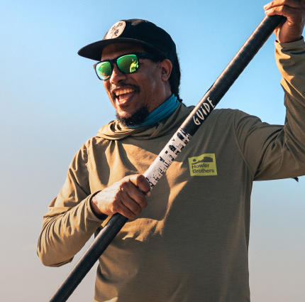 Man smiling wearing green mirror sunglasses