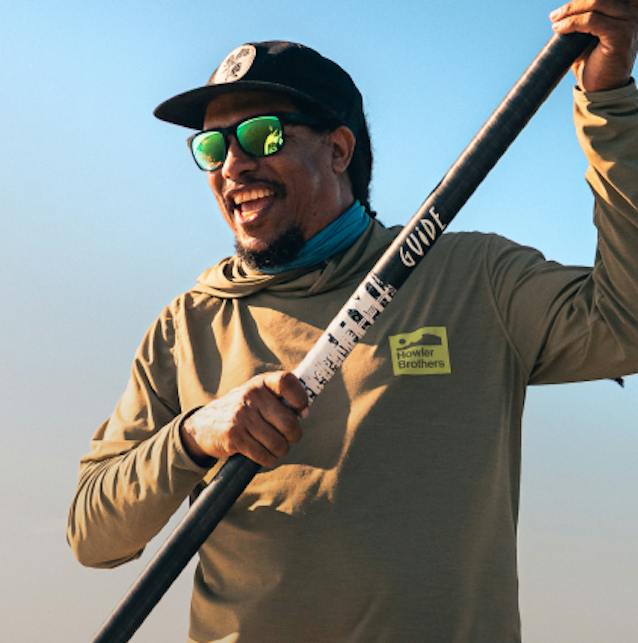 Man smiling wearing green mirror sunglasses