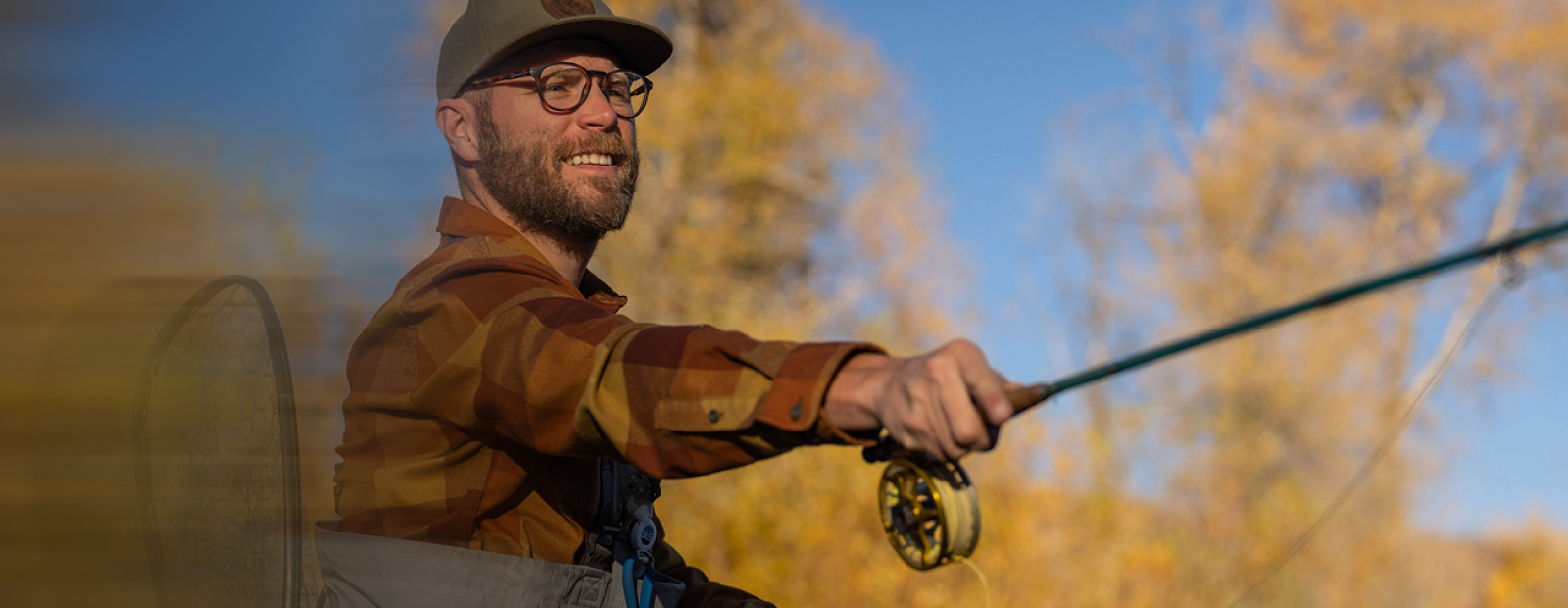 Man casting fishing rod wearing Oslo eyeglasses