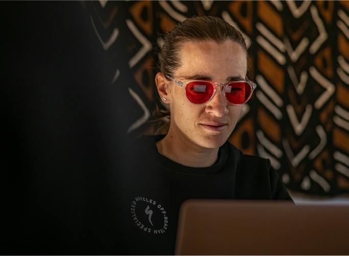 Woman using laptop wearing Wind Down eyewear
