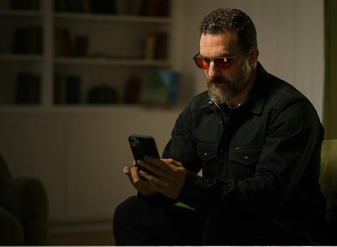 Man using phone wearing Wind Down glasses