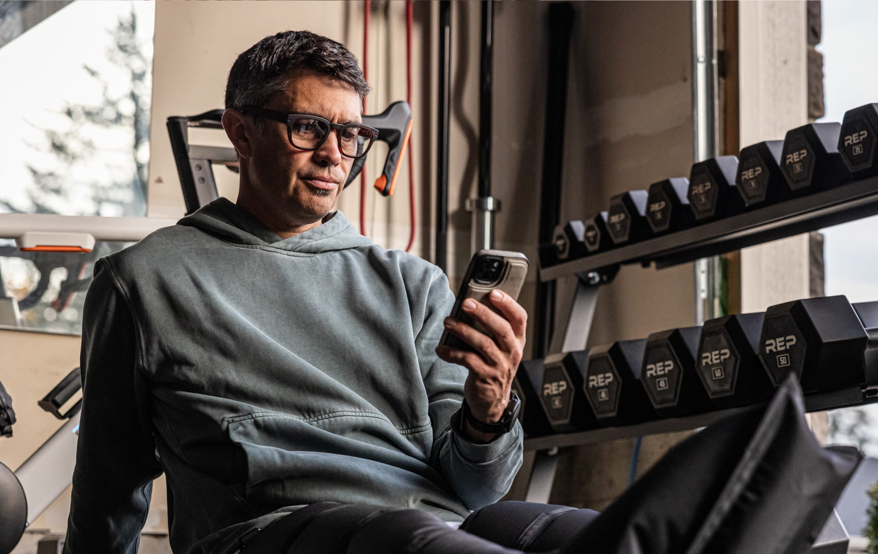 Man on phone near weights