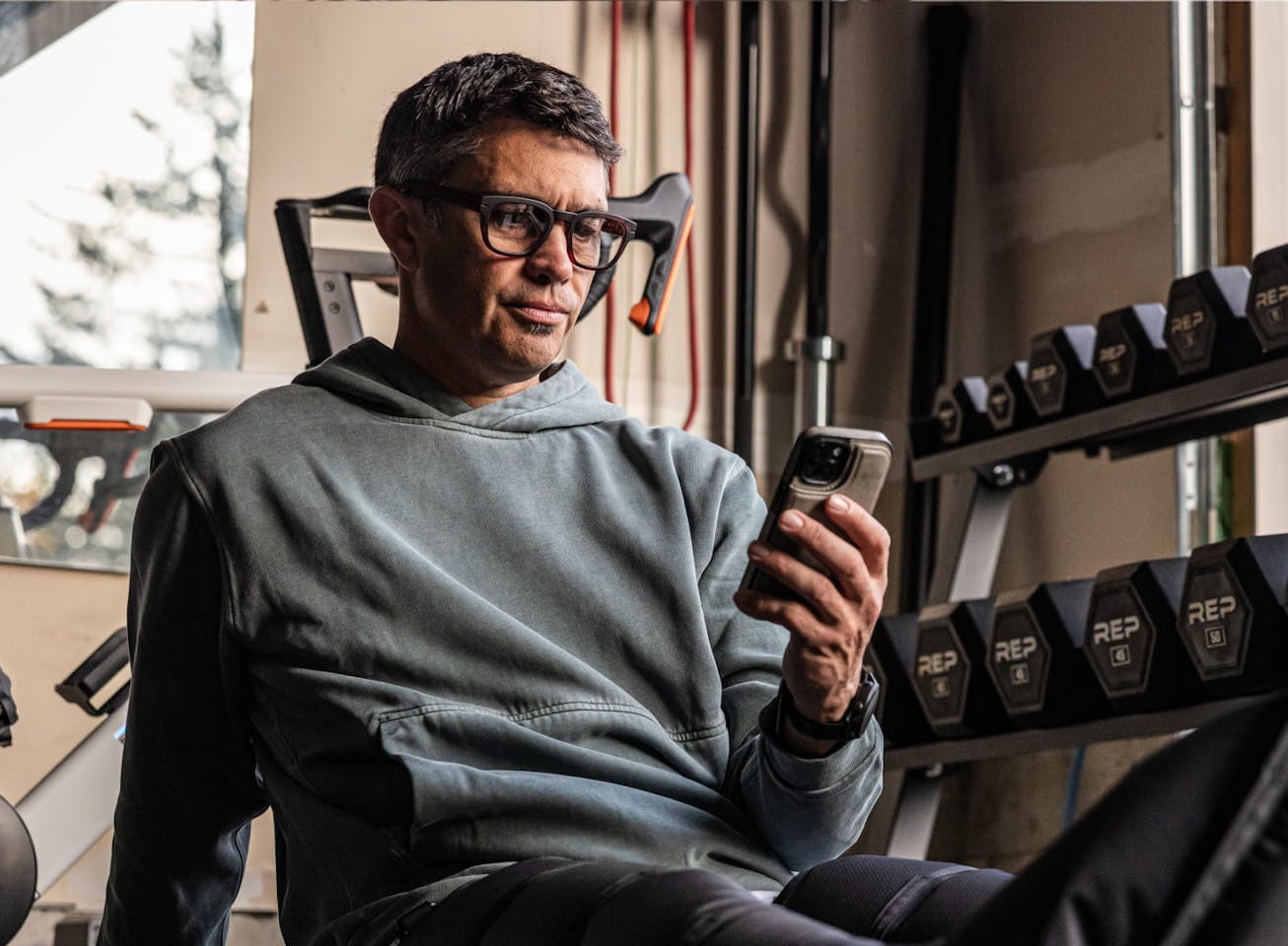 Man on phone near weights