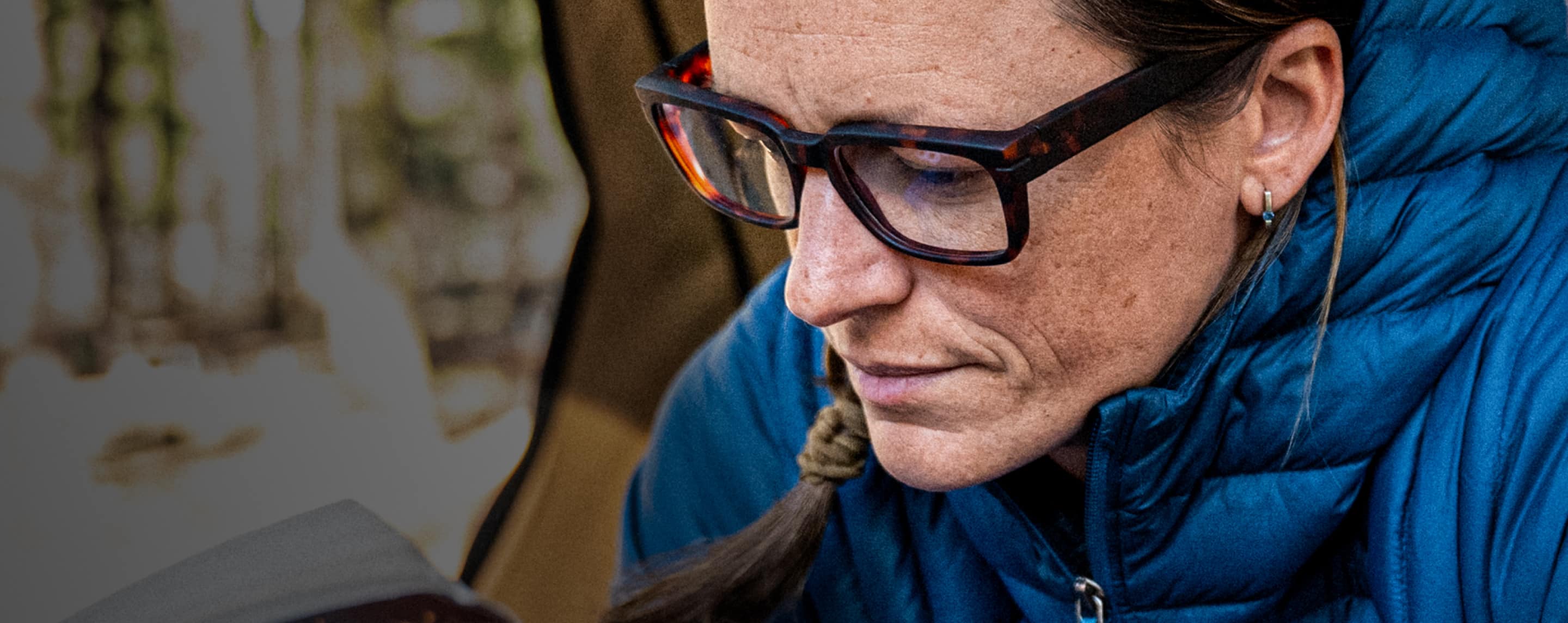 Woman in blue jacket and whistler eyeglasses