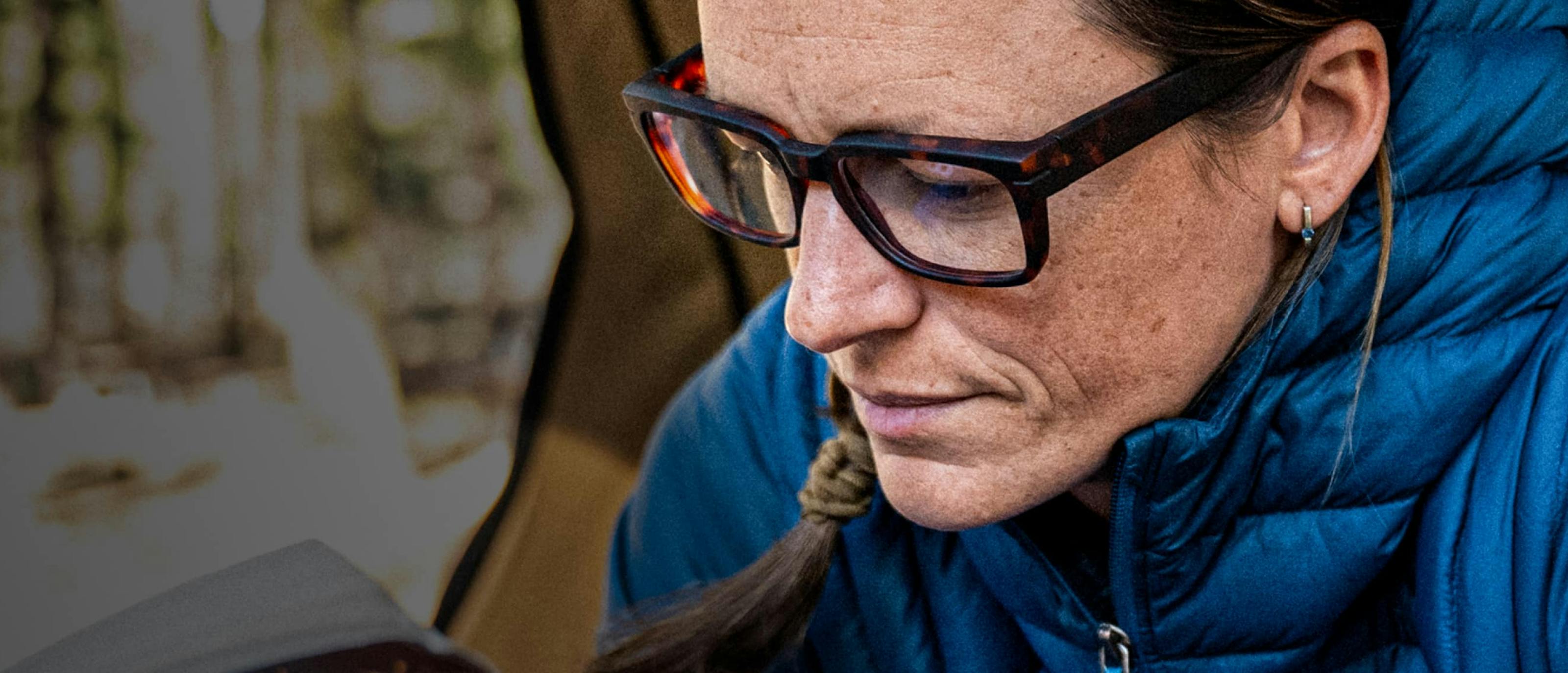 Woman in blue jacket and whistler eyeglasses