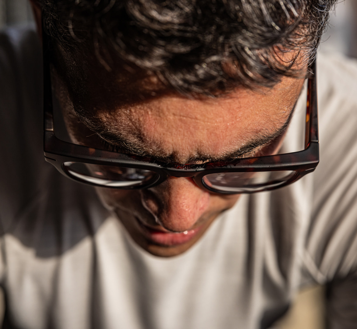 Man looking down in Cooper eyeglasses