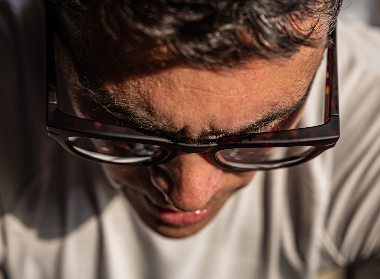 Man looking down in Cooper eyeglasses