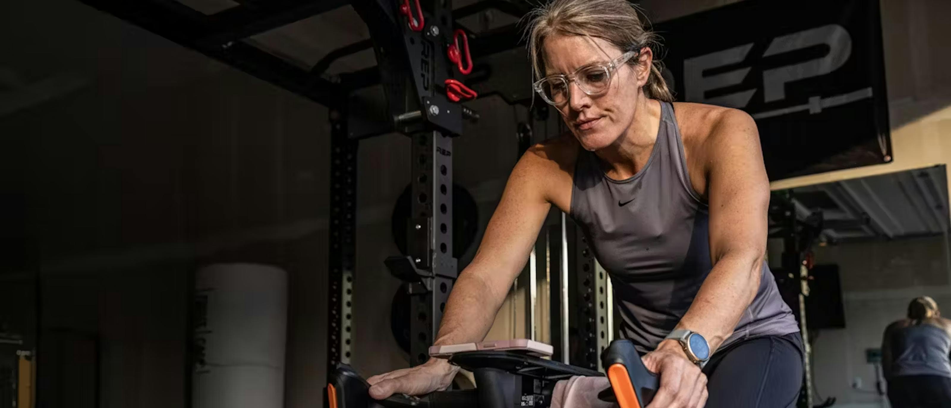Woman on indoor bike wearing Cooper eyeglasses