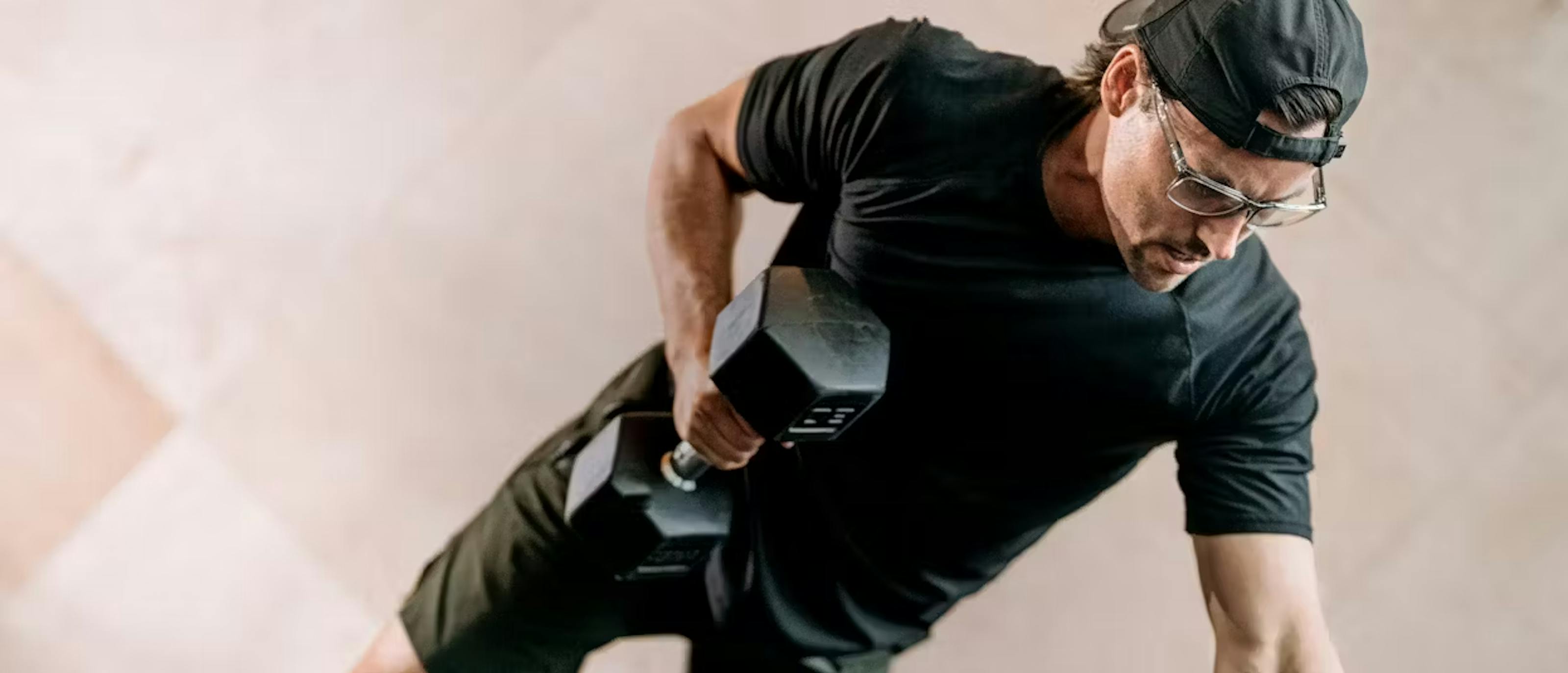 Man using dumbbell wearing Barton eyeglasses
