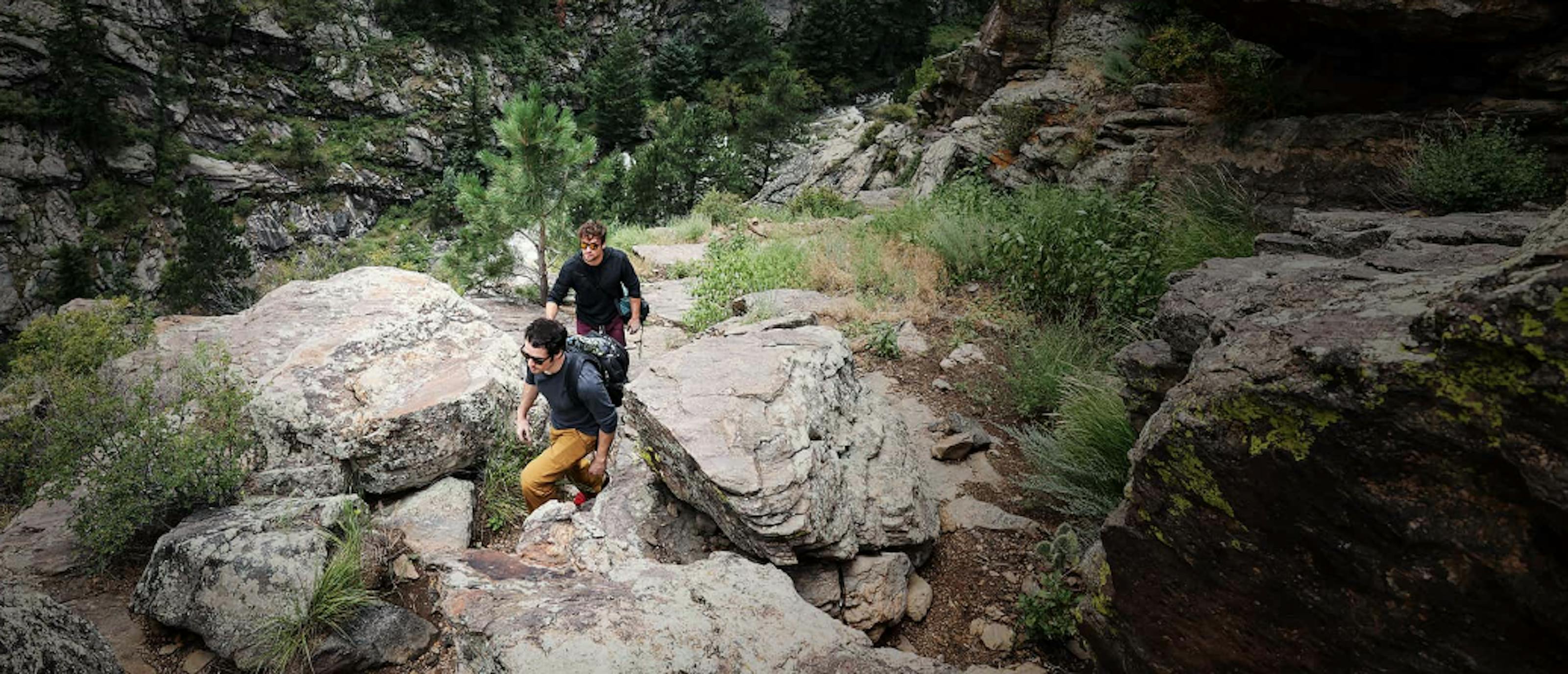 Men hiking in rocky woods