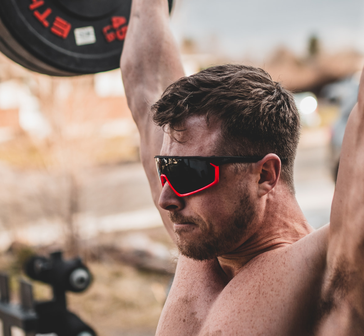 Man powerlifting outdoors in CP-1x sunglasses