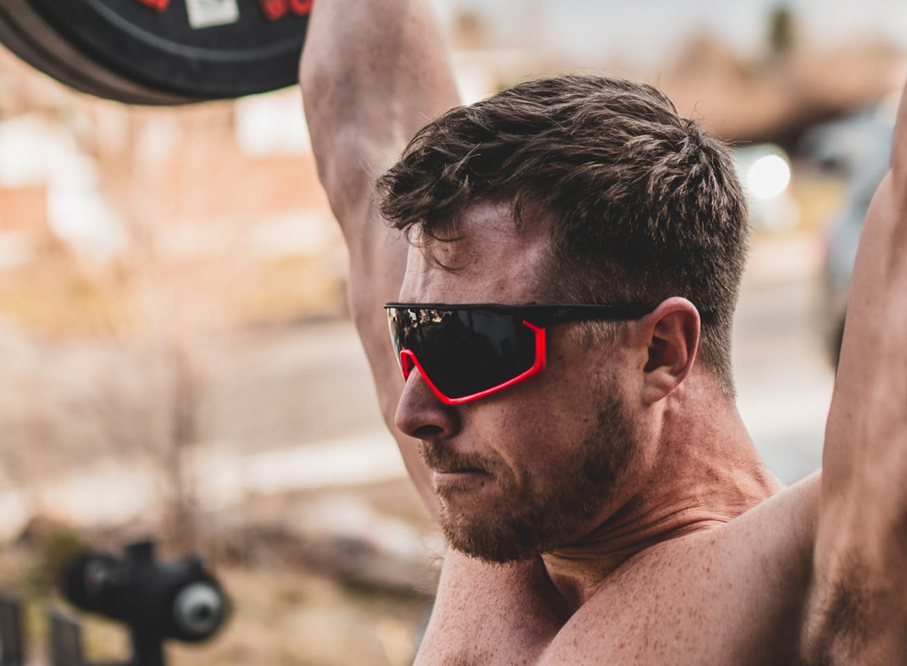 Man powerlifting outdoors in CP-1x sunglasses