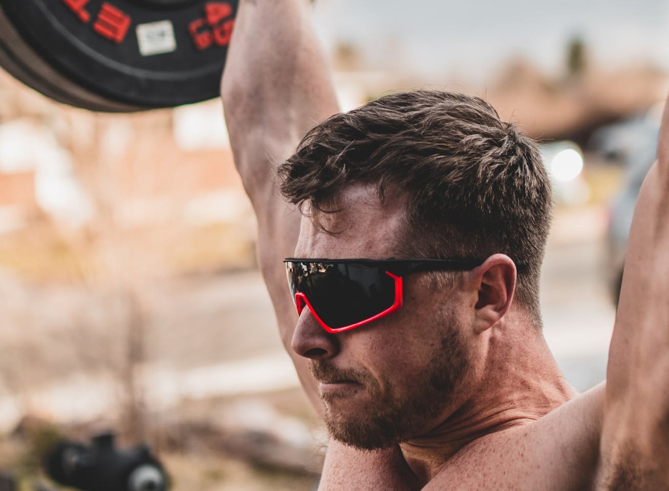 Man powerlifting outdoors in CP-1x sunglasses