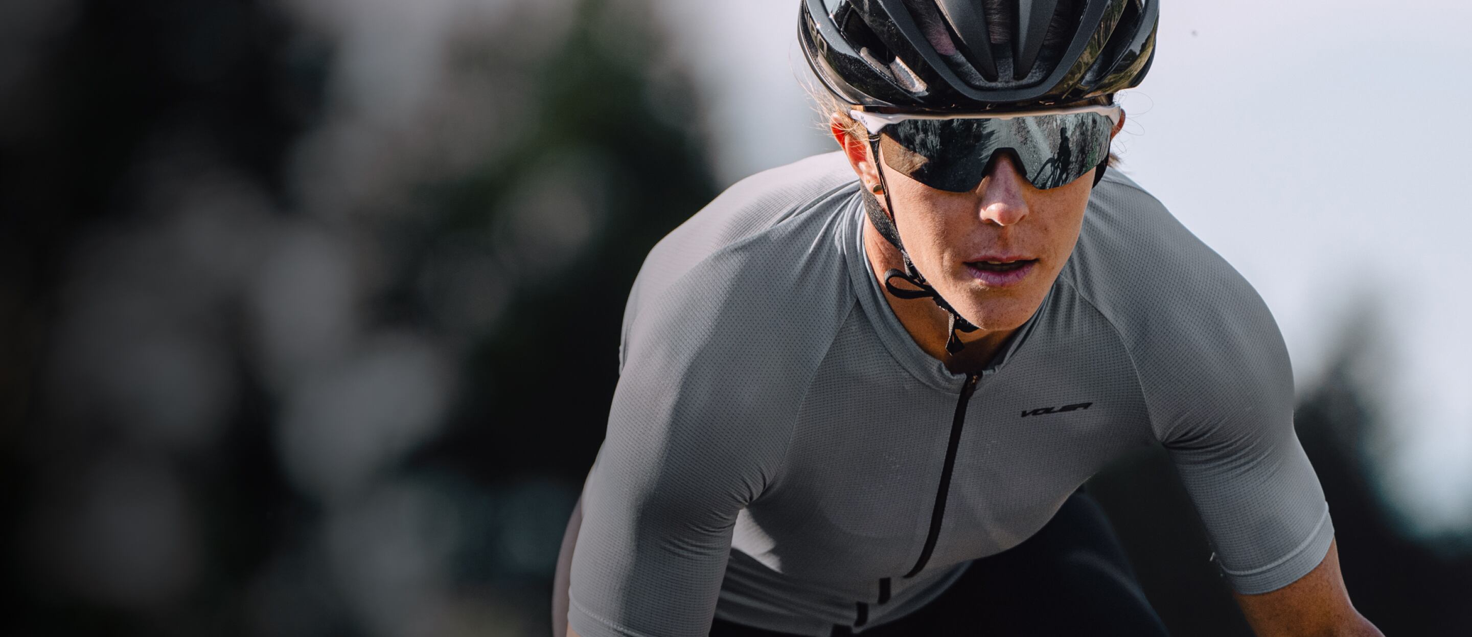 Woman in grey cycling suit and SR-1x sunglasses
