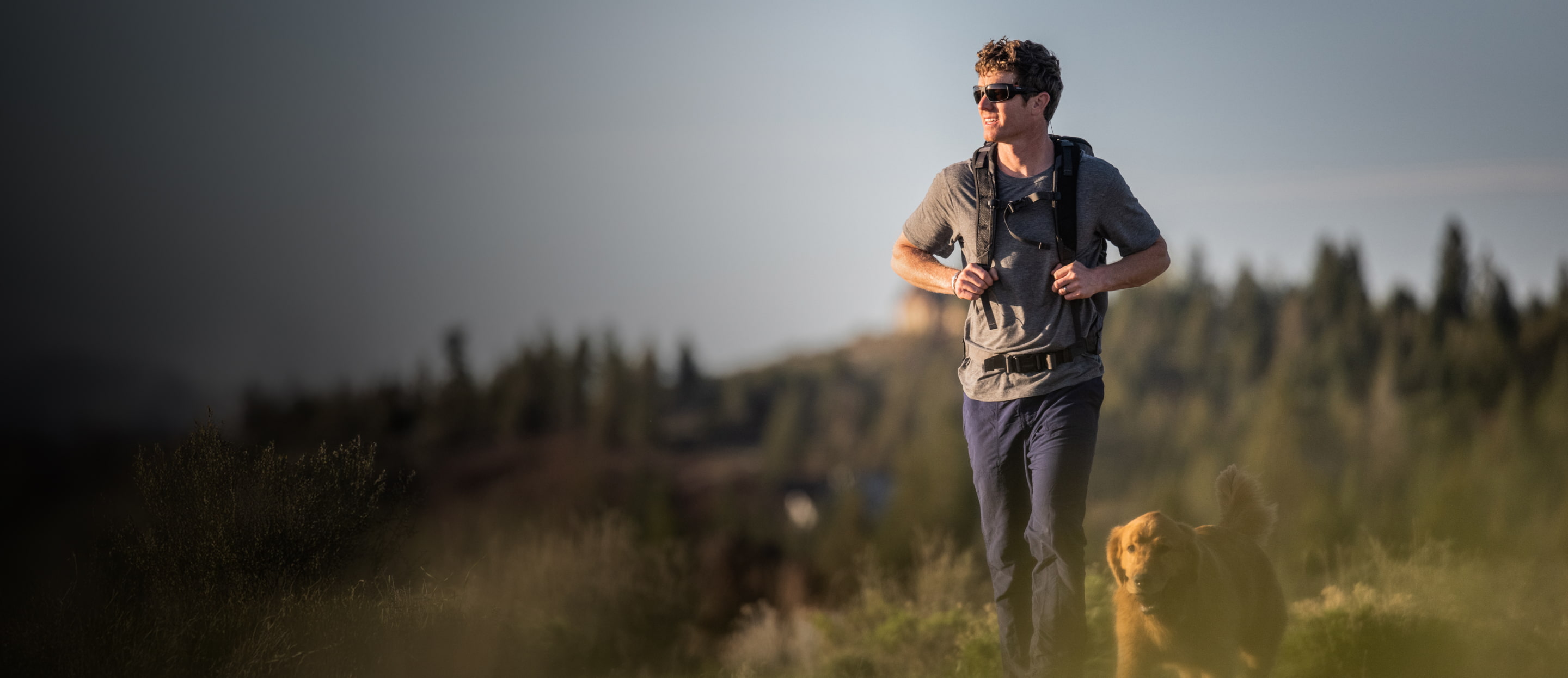Man hiking with golden retriever dog