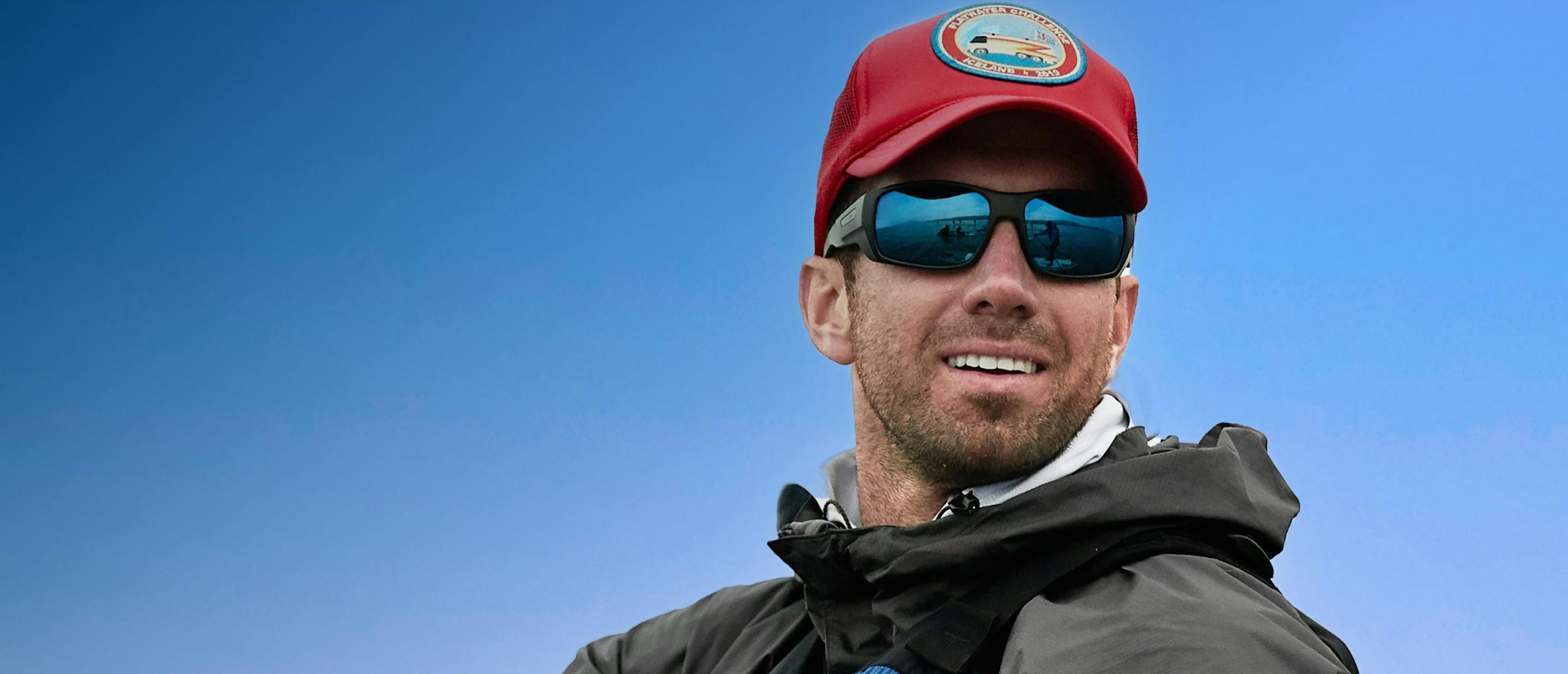 Man in red hat and AT-1 sunglasses